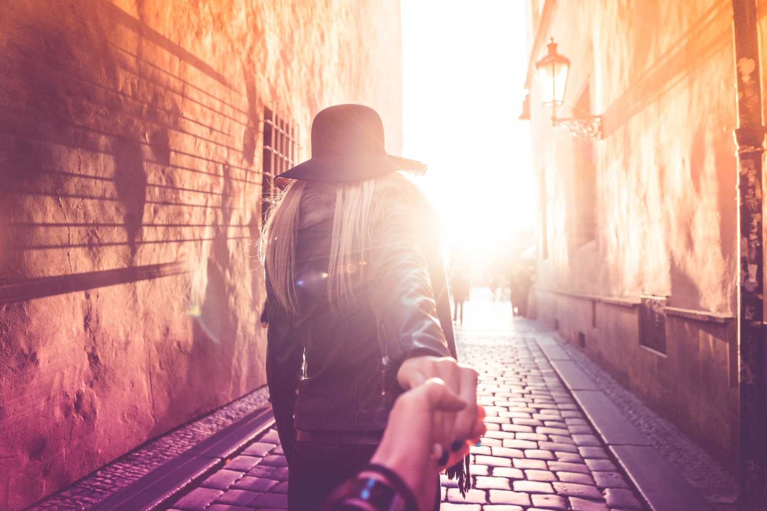 Free stock photo of Young Woman Presents Follow Me To Pose in Prague Streets from picjumbo.com